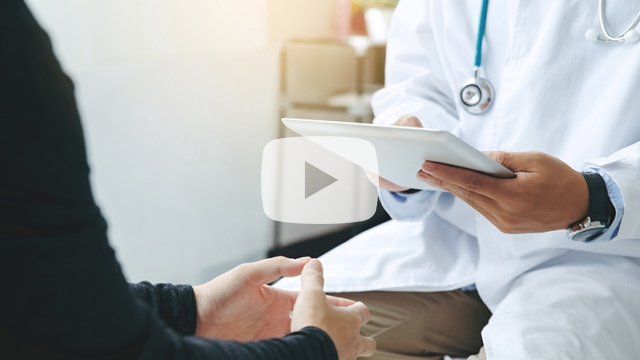 Doctor with tablet talking with patient